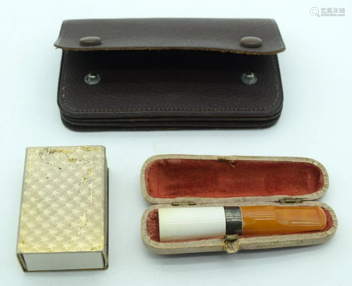 An amber Cheroot holder with a silver collar together