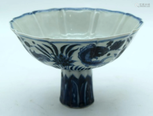A Chinese blue and white stem cup decorated with fish.
