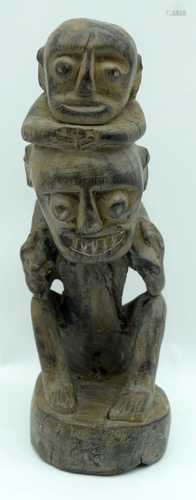 A Nigerian wooden figure of a child on a mans shoulders