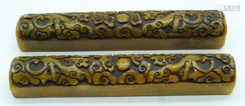 A pair of carved hardstone scroll weights 21cm (2) .