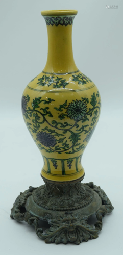 A Chinese yellow ground vase on a bronze embossed stand