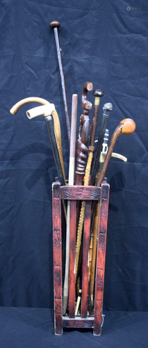 A collection of walking sticks, golf club, umbrella etc