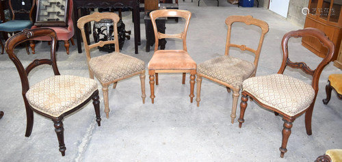 A collection of five upholstered wooden dining chairs