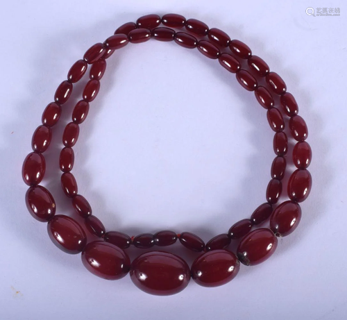 A 1930S CHERRY AMBER NECKLACE. 61 grams. 76 cm long,