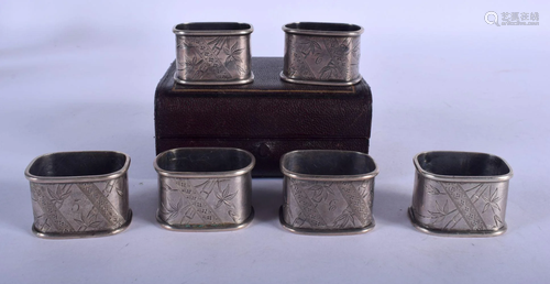 A SET OF SIX AESTHETIC MOVEMENT SILVER NAPKIN RINGS.