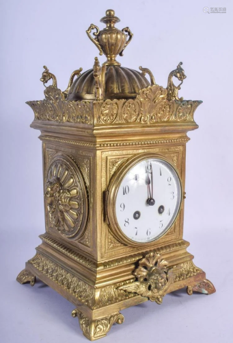 AN ANTIQUE FRENCH BRASS MANTEL CLOCK decorated with