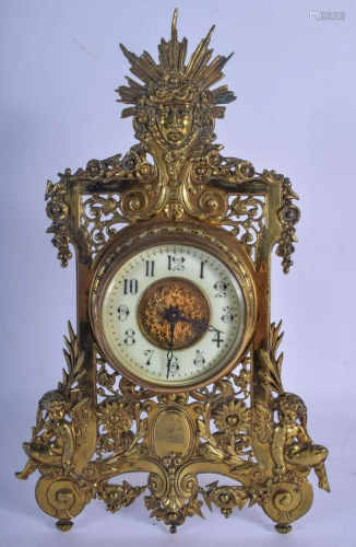 AN ANTIQUE FRENCH BRASS MANTEL CLOCK formed with