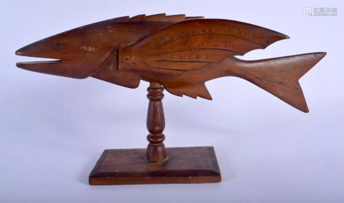A VINTAGE PITCAIRN ISLANDS FIGURE OF A FLYING FISH upon