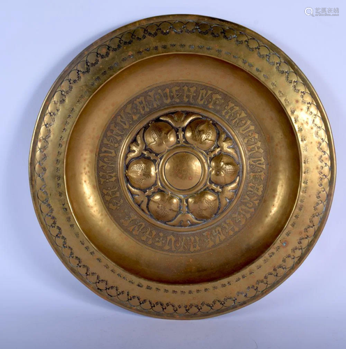 AN ARTS AND CRAFTS BRASS PANEL. 43 cm diameter.