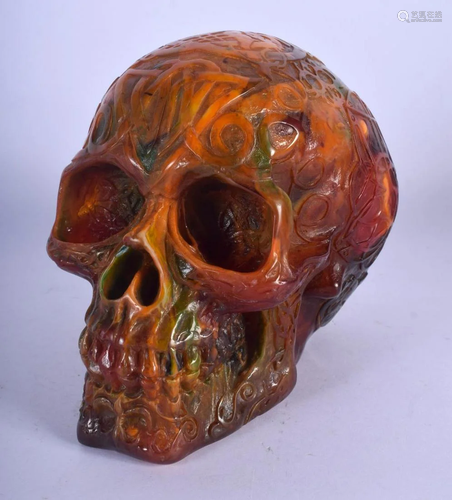 A CONTEMPORARY AMBER TYPE SKULL. 16 cm x 14 cm.