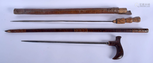 TWO EARLY 20TH CENTURY SOUTH EAST ASIAN SWORD STICKS.