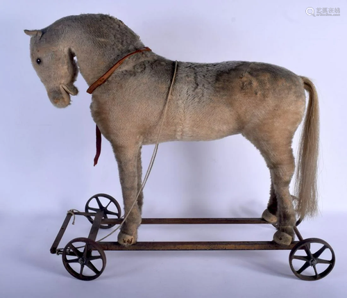 AN EARLY 20TH CENTURY CHILDS PLUSH HORSE PULL ALONG