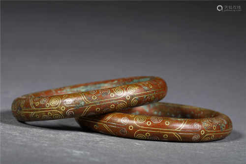 A PAIR OF BRONZE RINGS WITH GOLD INLAYS