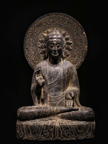 A STONE SITTING BUDDHA STATUE