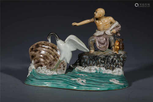 A PORCELAIN DISPLAY FIGURINE