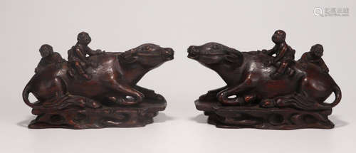 PAIR OF CHENXIANG WOOD CHILD RIDING BUFFALO PENDANTS