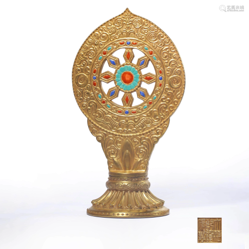 A GOLD PAINTED DHARMA WHEEL ORNAMENT