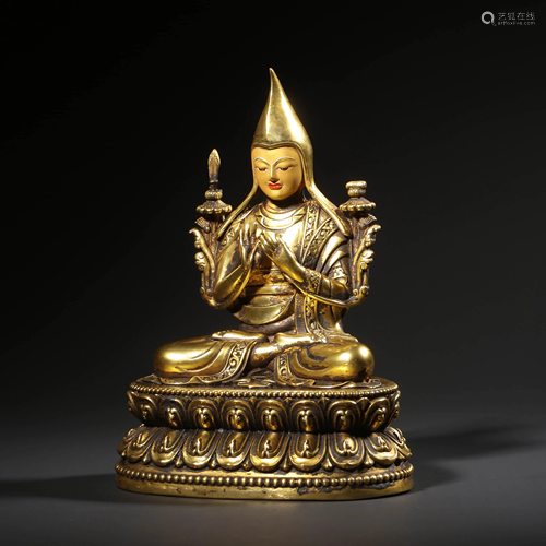 A GILT-BRONZE STATUE