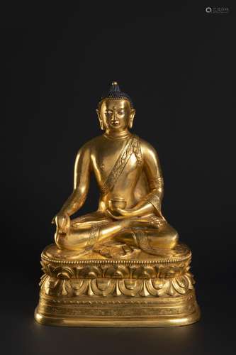 A CHINESE GILT-BRONZE FIGURE OF THE MEDICINE BUDDHA