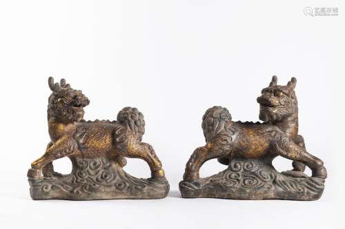 A PAIR OF CHINESE GILT CAST-IRON BUDDHIST QI-LIN LIONS