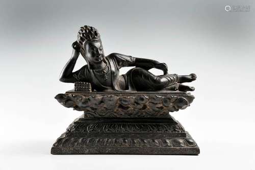 A CHINESE RECLINING GUANYIN CAST-IRON FIGURE