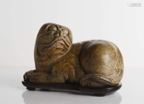 A CHINESE SOAPSTONE RECUMBENT FOO DOG