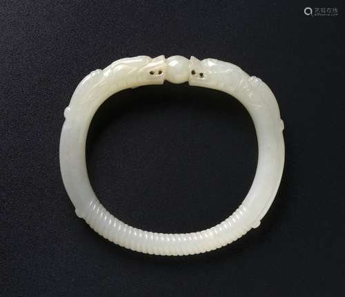 A CHINESE PALE CELADON JADE 'DRAGON' BANGLE