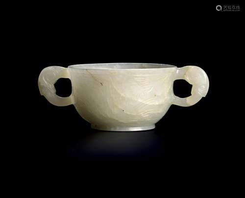 A CHINESE PALE GREEN JADE CUP WITH RAM HANDLES