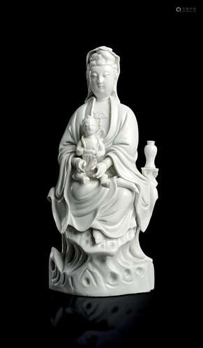 A CHINESE BLANC-DE-CHINE FIGURE OF GUANYIN AS THE 'BRINGER O...