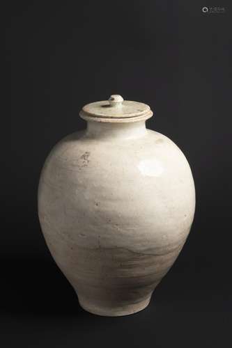 A WHITE GLAZED POTTERY JAR AND COVER