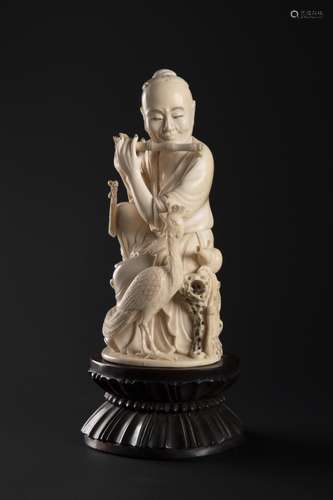 A CARVED IVORY FIGURE OF THE IMMORTAL HAN XIANGZI