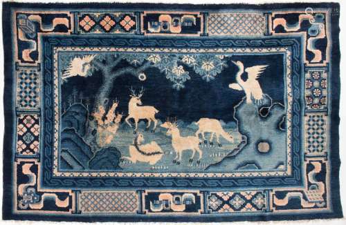 A BLUE CARPET WITH ANIMALS AND AUSPICIOUS SYMBOLS