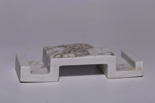 A WHITE-GLAZED PORCELAIN INK REST