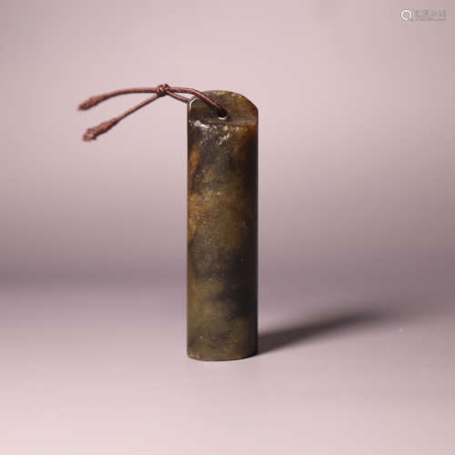 A carved jade tube