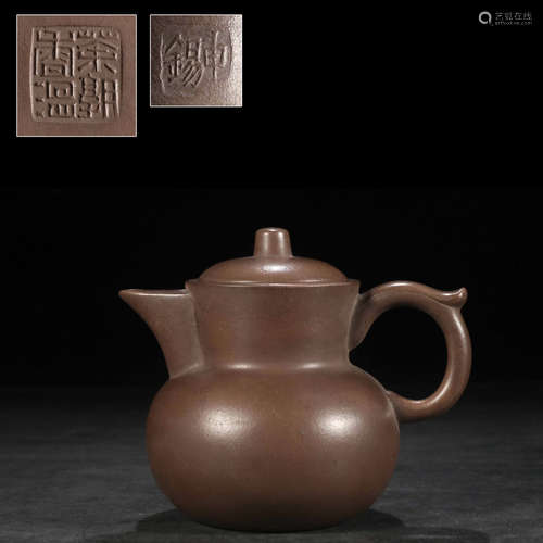 A purple clay monk’s jug ewer