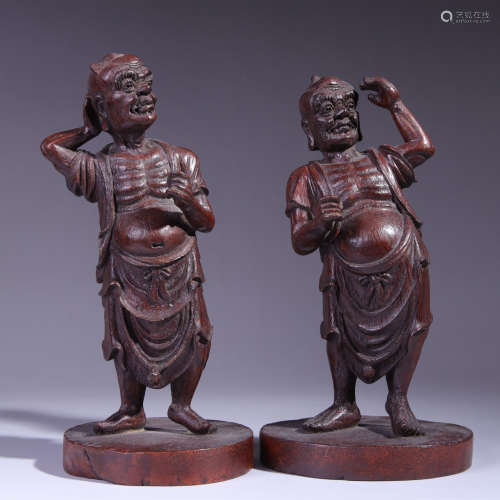 A pair of carved bamboo figures