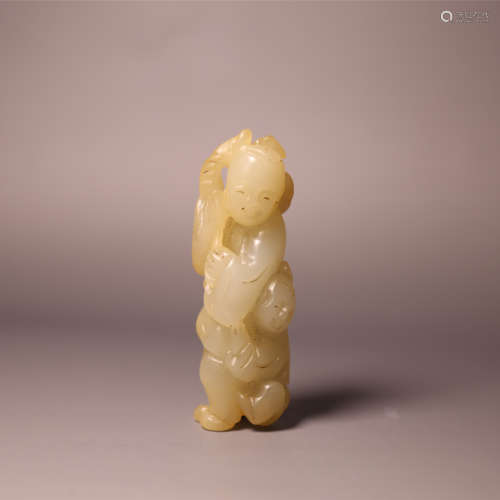 A carved jade boy and lotus
