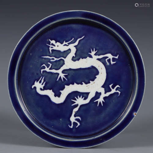 A reverse-decorated blue-glazed charger