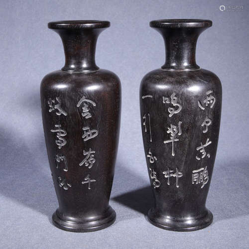 A pair of sandalwood inscribed vases