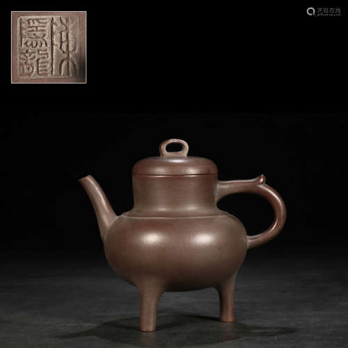 A purple clay tripod teapot