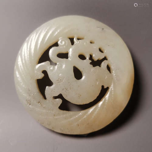 A carved white jade dragon ornament