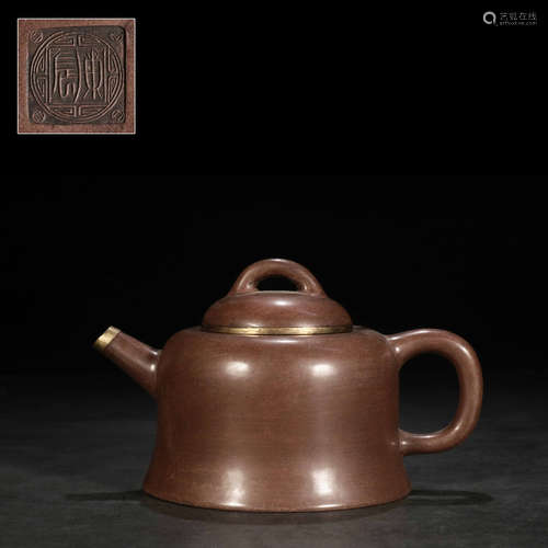 a polished bronze-coated teapot