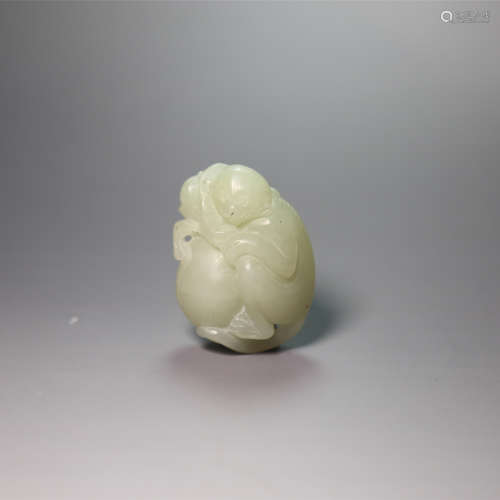 A carved white jade monkey and peach