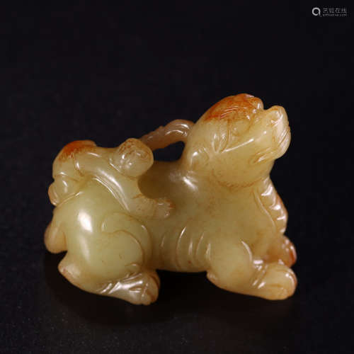 A carved yellow jade kylin and child