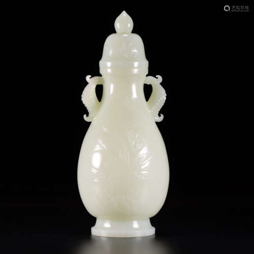 a carved white jade dragonfly and lotus vase and cover