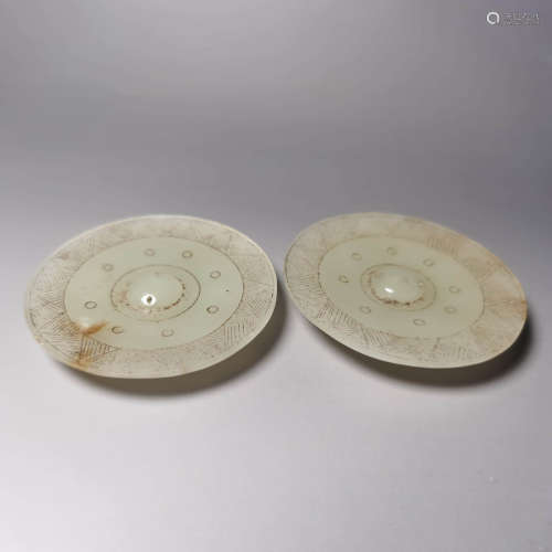 A pair of carved jade circular mirrors