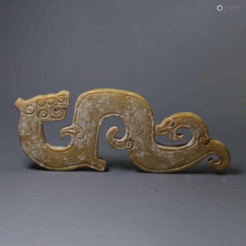 A carved jade s-shaped dragon pendant