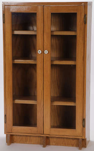 A CHILD'S OAK BOOK CASE