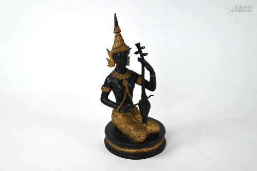 A Thai gilt bronze figure of a kneeling deity, 24 cm