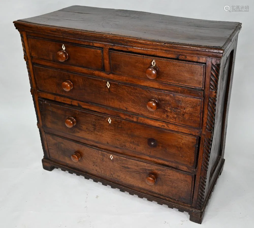 An antique oak chest of two short over three long